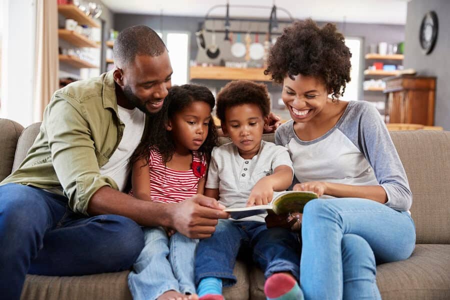 Parent organizing a child's portfolio, scanning documents and working at a desk